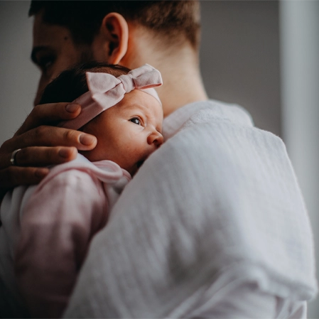 Chiropractic Grand Rapids MI Man Holding Baby