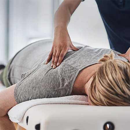 Chiropractic Grand Rapids MI Woman Receiving Adjustment