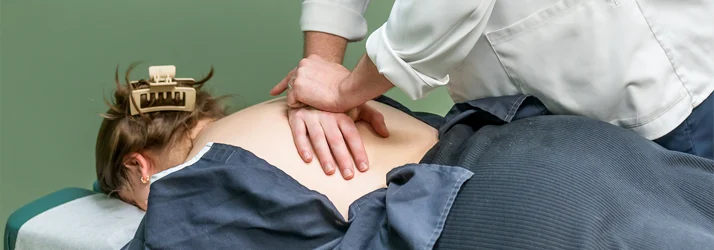 Chiropractor Grand Rapids MI Connor Knapp Adjusting Back Pain Patient Chiropractor Grand Rapids MI Connor Knapp Adjusting Back Pain Patient