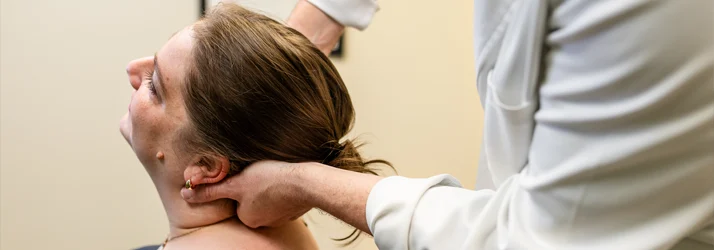 Chiropractor Grand Rapids MI Connor Knapp Adjusting Head Pain Patient Chiropractor Grand Rapids MI Connor Knapp Adjusting Head Pain Patient