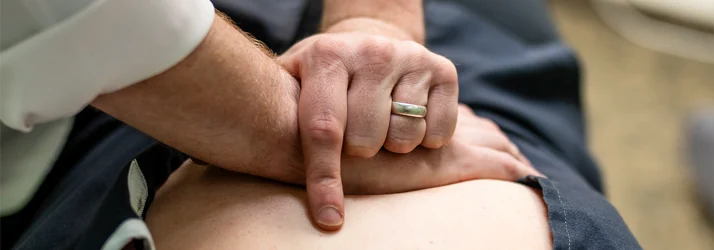 Chiropractor Grand Rapids MI Connor Knapp Adjusting Low Back Pain Patient