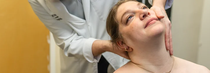 Chiropractor Grand Rapids MI Connor Knapp Adjusting Neck Pain Patient Chiropractor Grand Rapids MI Connor Knapp Adjusting Neck Pain Patient