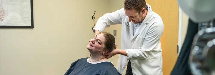 Chiropractor Grand Rapids MI Connor Knapp Adjusting Patient Neck Chiropractor Grand Rapids MI Connor Knapp Adjusting Patient Neck