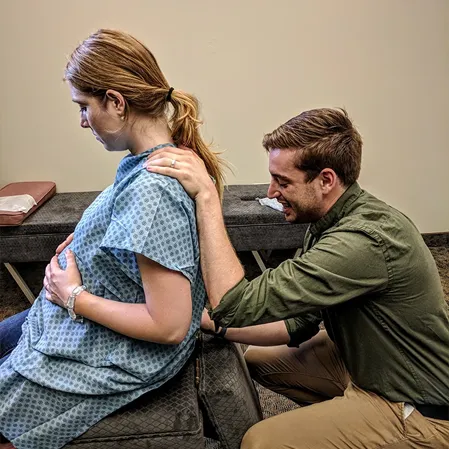 Chiropractor Grand Rapids MI Connor Knapp Adjusting Pregnant Patient